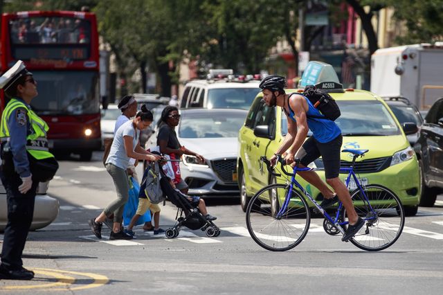 A bicyclist rides in a Brooklyn street.